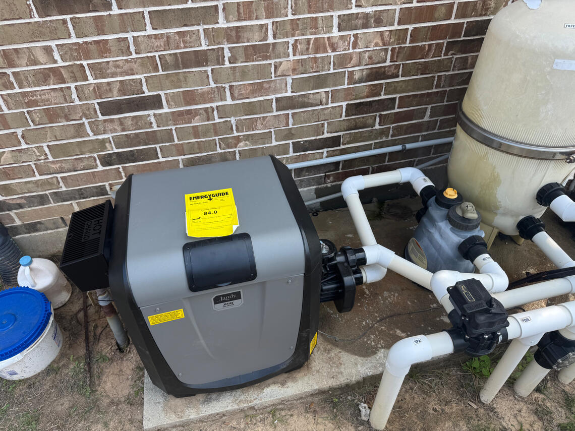 Professional after install picture of a Jandy JXIQ pool heater in Fulshear Texas by Drew Pools.